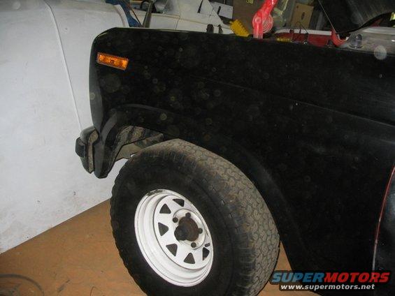 1981 Ford Bronco front fender and tire, black paint with dust spots