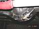 1990 Ford Bronco - Underside view of vehicle differential and suspension components with a red hose visible.