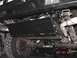 1990 Ford Bronco - The photo shows the undercarriage of a vehicle, focusing on the rear axle and suspension components.