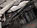 1990 Ford Bronco - Undercarriage view reveals the driveshaft, suspension, and exhaust system of a vehicle.