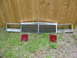 1985 Ford Crown Victoria LTD - Front end parts including a chrome grille, headlight assemblies, and LTD taillights are laid out on the grass.