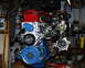 1978 Nissan 240SX - This engine features a turbocharger and is painted with red and blue accents.