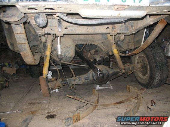 Rear axle assembly of a 1981 Ford Bronco with leaf springs removed, showing shocks and differential