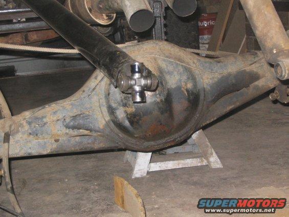 Rear axle assembly with driveshaft and U-joint, supported by jack stands