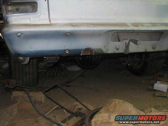 Rear bumper with exhaust cutout and visible suspension components