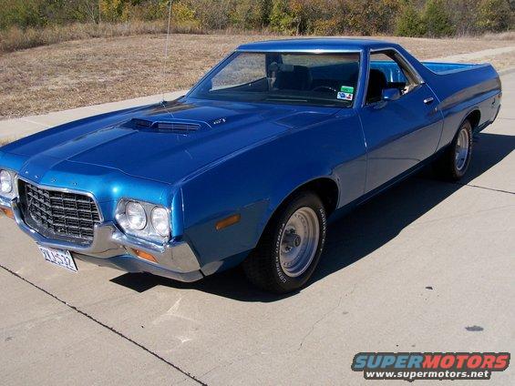 Blue 1972 Ford Ranchero with a hood scoop and chrome bumper, parked on pavement
