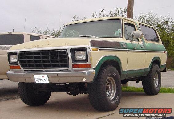 Tan and green 1978 Ford Bronco with aftermarket wheels and tires, front 3/4 view