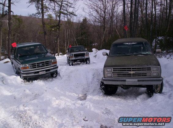 Green 1995 Ford Bronco in snow, front view