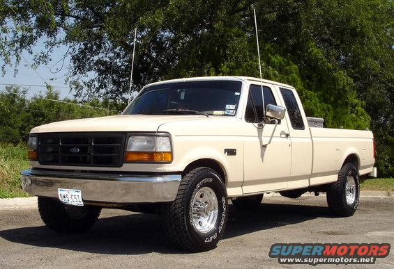 Cream-colored Ford F-250 pickup truck, four doors, parked outside