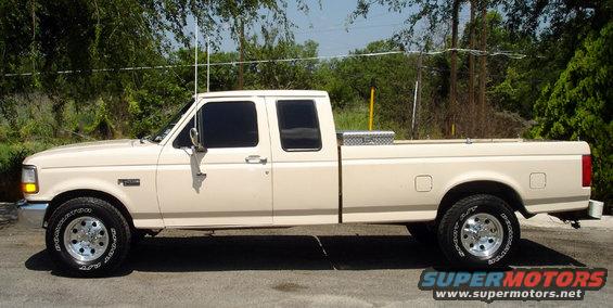 1993 Ford F-250 extended cab pickup truck, side view, cream color, with a toolbox in the bed
