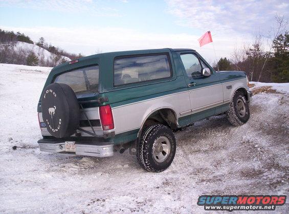 1996 Ford Bronco rear view in snow, green and silver