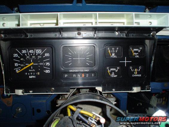 Dashboard gauges with speedometer, fuel, oil, temp, and charge indicators