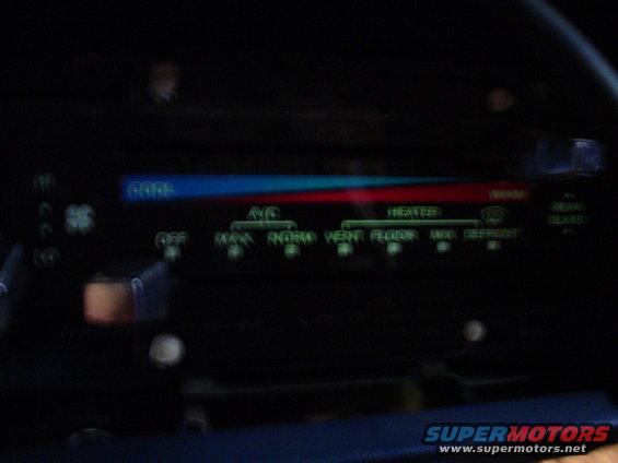 Climate control panel with blue/red temperature slider and green text labels for AC, Heater, Vent, Floor, Defrost