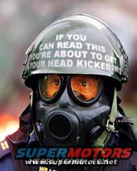 Gas mask and helmet with text 'IF YOU CAN READ THIS YOU'RE ABOUT TO GET YOUR HEAD KICKED IN'