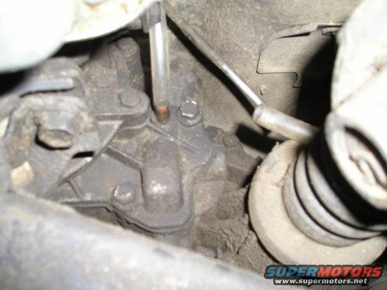 Close-up of a vehicle's transmission with a clear fluid level tube