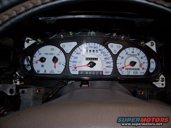 Dashboard gauges with odometer reading 097453, speedometer up to 150 MPH, and tachometer