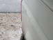 1989 Ford Bronco - The rear quarter panel of a white 1989 Ford Bronco shows some wear and tear.