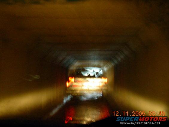 Cars driving through a tunnel at night, lights blurred