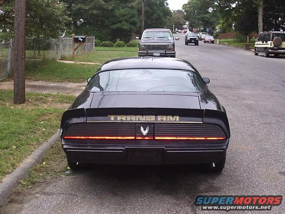 Black 1979 Pontiac Trans Am rear view with gold lettering