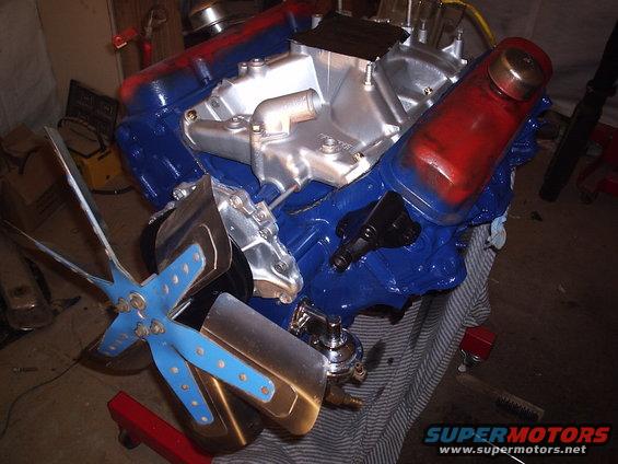 Blue and red painted engine block with a silver intake manifold and a blue fan with chrome shroud