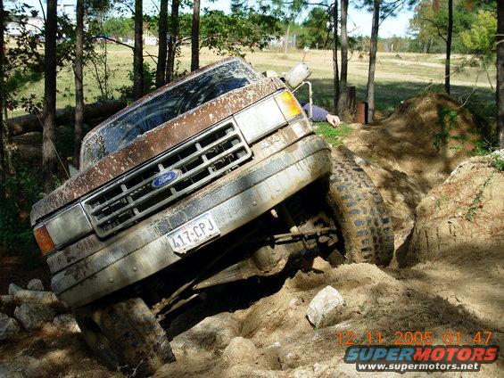 Ford truck stuck on rocky, muddy trail. License plate 417-CPJ visible