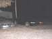1996 Ford Mustang - Three Ford Mustangs are parked outside at night, with a silver one in the foreground.