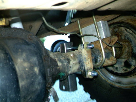 Rear axle with U-bolts and a shock mount bracket