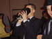 1996 Ford Probe - A man in formal wear holds a large microphone, possibly at an event.