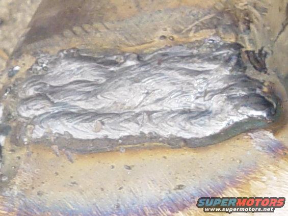 close-up of a metal weld seam with discoloration