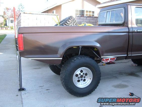 1985 Ford Ranger pickup truck with a Hi-Lift jack on the rear bumper and a spare tire in the bed