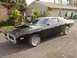 1993 Ford Bronco - This black 1973 Dodge Charger SE features a prominent hood scoop and classic chrome wheels.