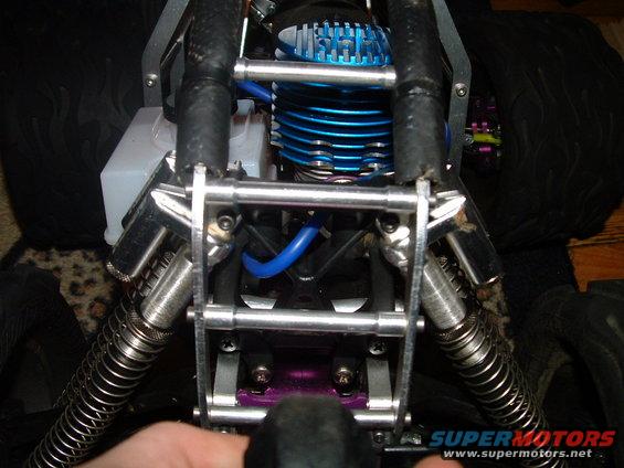 close-up of a remote control car engine with blue fins and black hoses