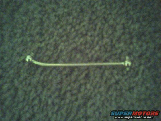Metal rod with white connectors on a textured background