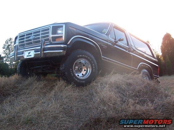 Ford Bronco parked on a grassy hill, front quarter view