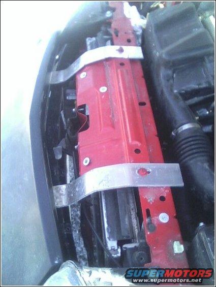 Engine bay radiator support with red painted metal and silver brackets