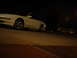 1993 Ford Probe - A white 1993 Ford Probe GT is parked on a street at night, with a house visible in the background.