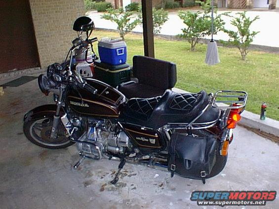 Honda motorcycle with saddlebags and a helmet on handlebars