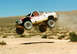 1998 Chevrolet C/K Pickup - This 1998 Chevrolet C/K Pickup is captured mid-air during an off-road race, its robust suspension and racing modifications.
