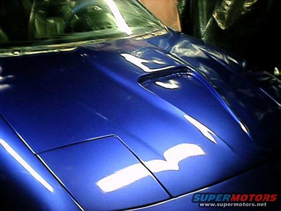 Blue 1993 Ford Probe hood with a scoop, showing pop-up headlights