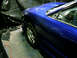1993 Ford Probe - A blue sports car is parked indoors, partially covered by black tarps, with a watermark at the bottom right.