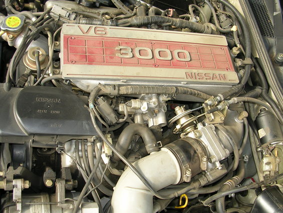 Nissan V6 3000 engine cover with visible Nissan branding and part numbers