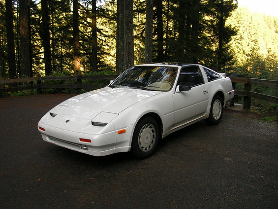 White 1989 Nissan 300ZX parked on asphalt with trees in background