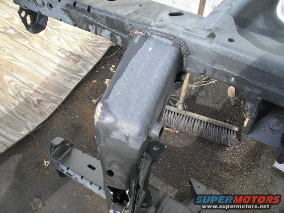 Vehicle frame section with a broom nearby