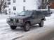 1996 Jeep Grand Cherokee - A black 1996 Jeep Grand Cherokee is parked on a snow-covered road in front of a building.