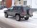 1996 Jeep Grand Cherokee - This 1996 Jeep Grand Cherokee is seen in a snowy environment, a rear-mounted spare tire and aftermarket bumper.