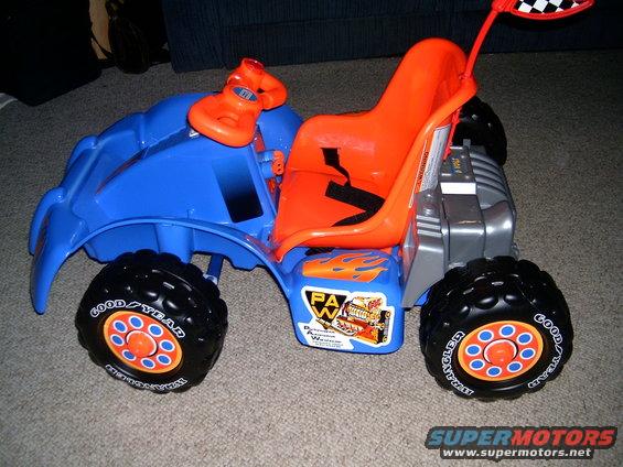 Blue and orange toy ride-on vehicle with "Goodyear" tires and flame decals