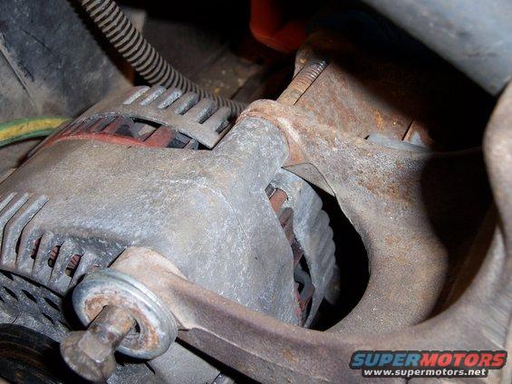 Alternator and rusty exhaust manifold in engine bay