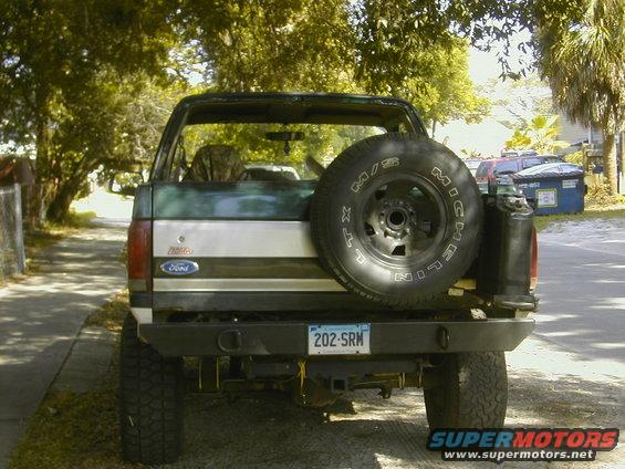 Rear view of a 1993 Ford Bronco with a spare tire mounted on the back. License plate reads 202-SRM