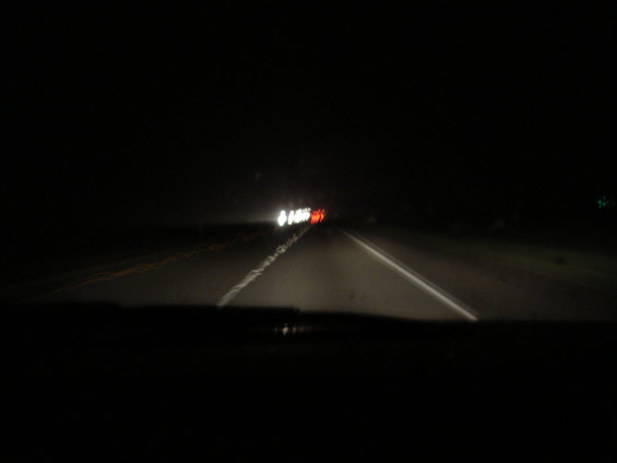 driving on highway at night, headlights and taillights visible
