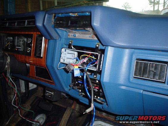 Dashboard of a truck with the stereo removed, showing wiring and vents